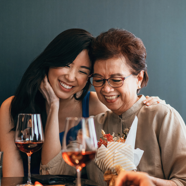 Daughter having family bonding with mother on Mother's Day.