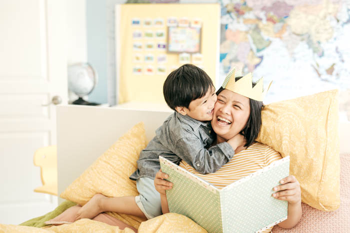 Mother playing with her son, after sorting out her family's finances