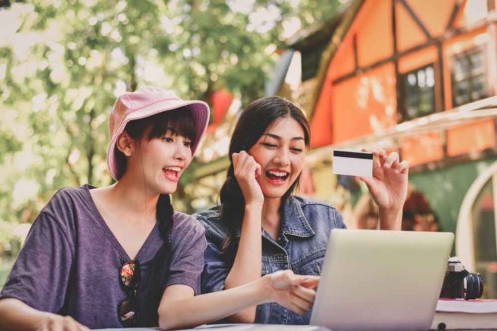 Two friends thinking about smart ways to spend their year end bonus