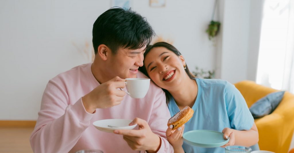 Happy married couple smiling at home