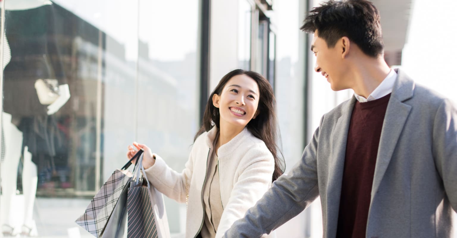 A couple smiling as they learned how to spend wisely during holiday season