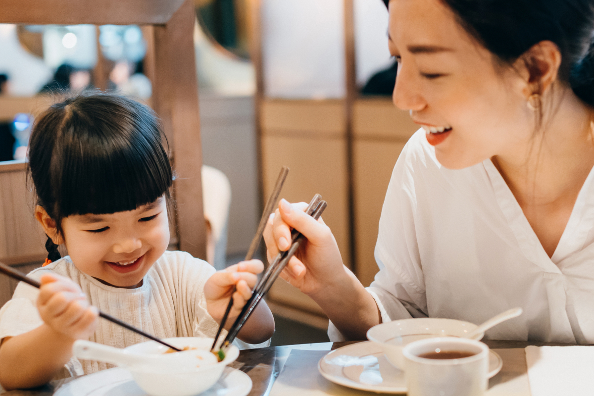 A girl and her mum enjoying a meal